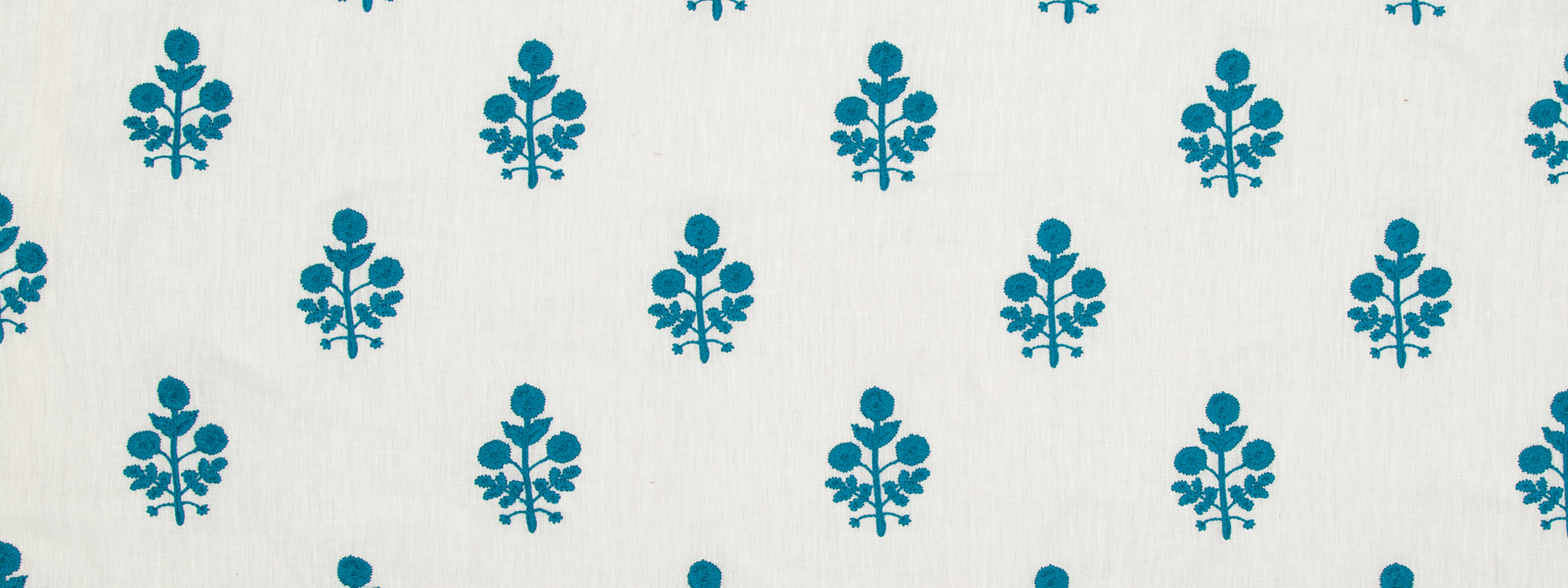 Turquoise blue floral motif repeating across a light background; decorative textile or wallpaper pattern.