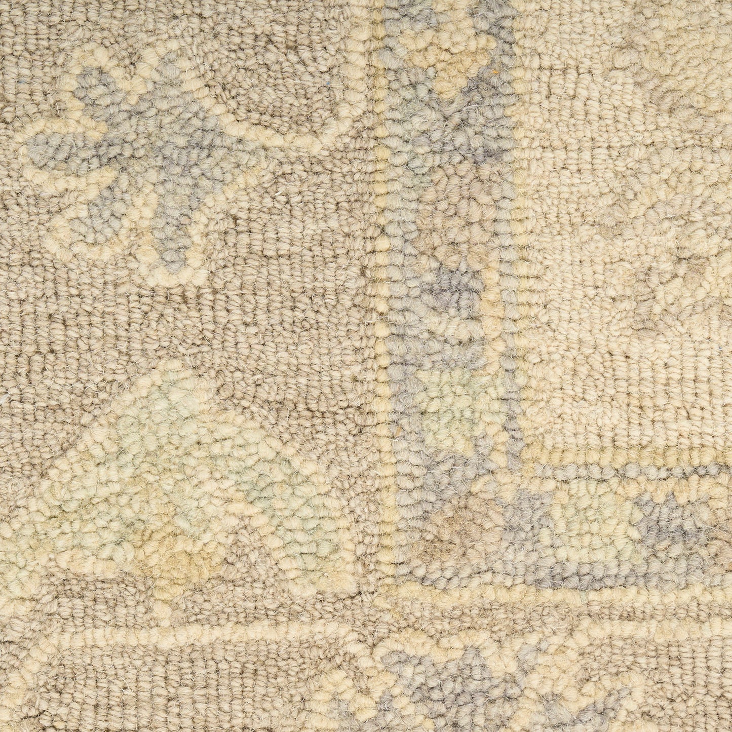 Beige textured rug with light blue-gray floral/scroll pattern; soft plush pile, decorative home decor.