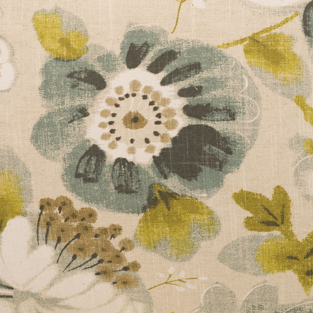 Beige fabric with large blue-green flower, white dotted center, olive leaves and yellow-green accents in a floral print.