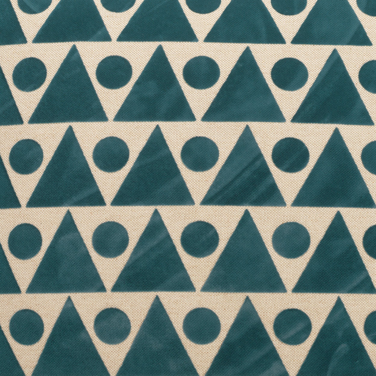 Teal triangle-and-circle geometric print on beige fabric; mid-century style upholstery textile.