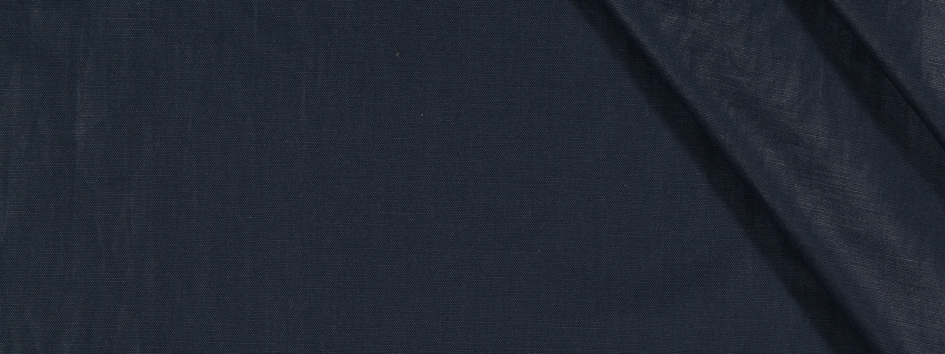 Dark navy fabric close-up with diagonal fold; smooth upholstery fabric.