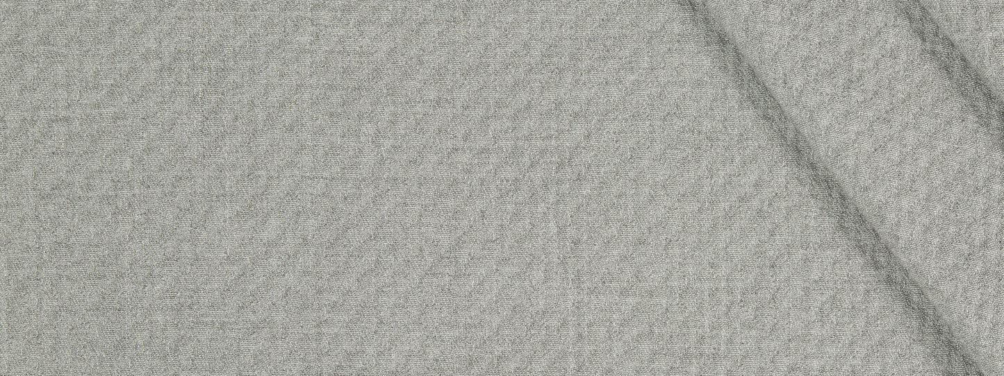 Beige textured woven fabric close-up with visible weave and a subtle fold.