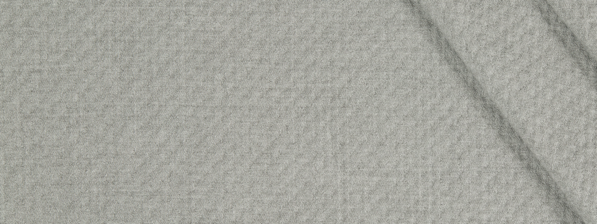 Beige textured woven fabric close-up with visible weave and a subtle fold.