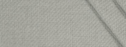 Beige textured woven fabric close-up with visible weave and a subtle fold.