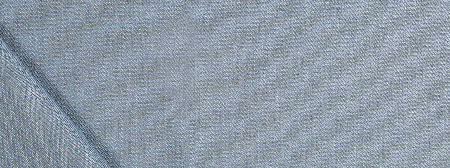 Close-up of light blue fabric with a subtle woven texture and a soft, denim-like appearance.