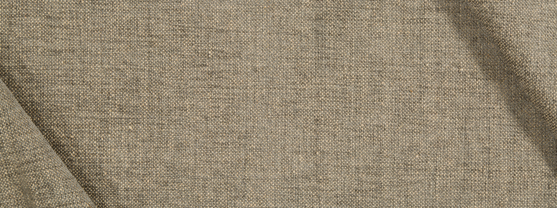 Beige jute chenille upholstery fabric close-up with visible weave and soft drape.