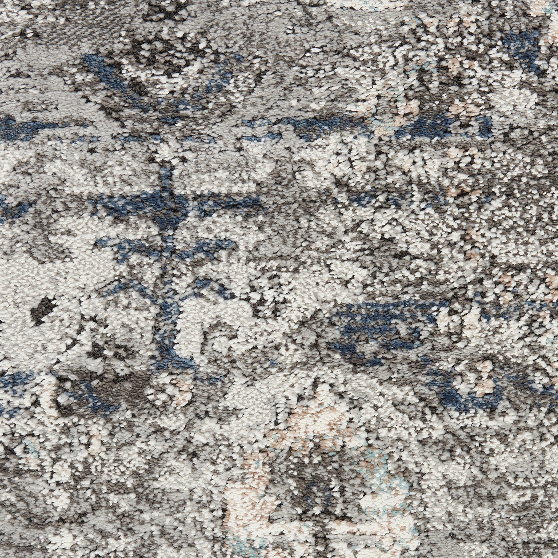 Distressed gray and beige oriental rug with blue accents and faded floral medallion pattern, plush pile.