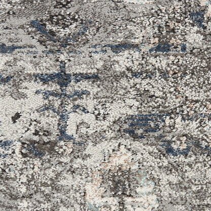 Distressed gray and beige oriental rug with blue accents and faded floral medallion pattern, plush pile.
