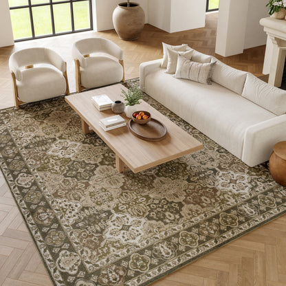 Bright living room with cream sofa, two beige armchairs, a wooden coffee table, and a green oriental rug.