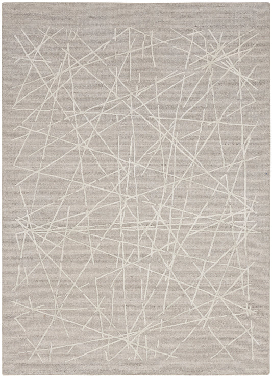 Beige-gray area rug with an abstract white crisscross line pattern.