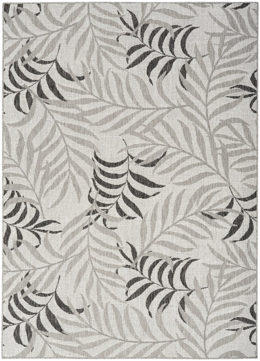 Rectangular gray area rug with light and dark palm leaf pattern; modern botanical design.