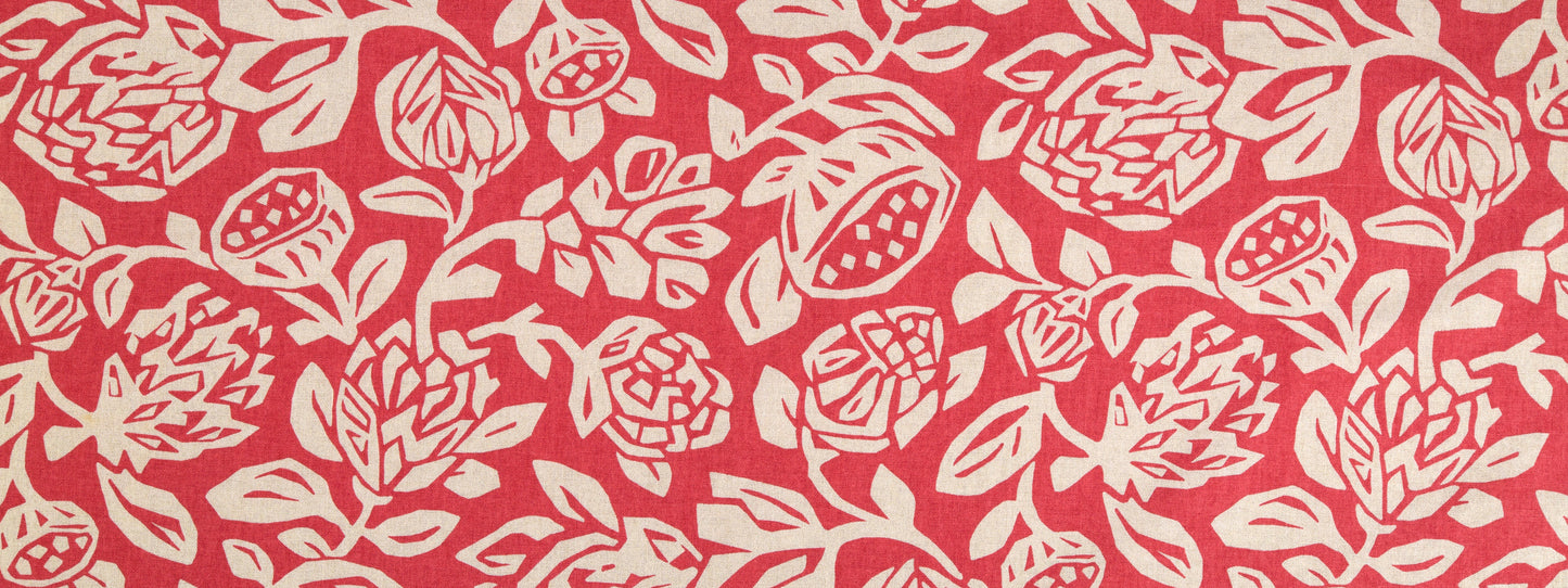 Coral fabric with white roses and leaves in a repeating floral pattern.