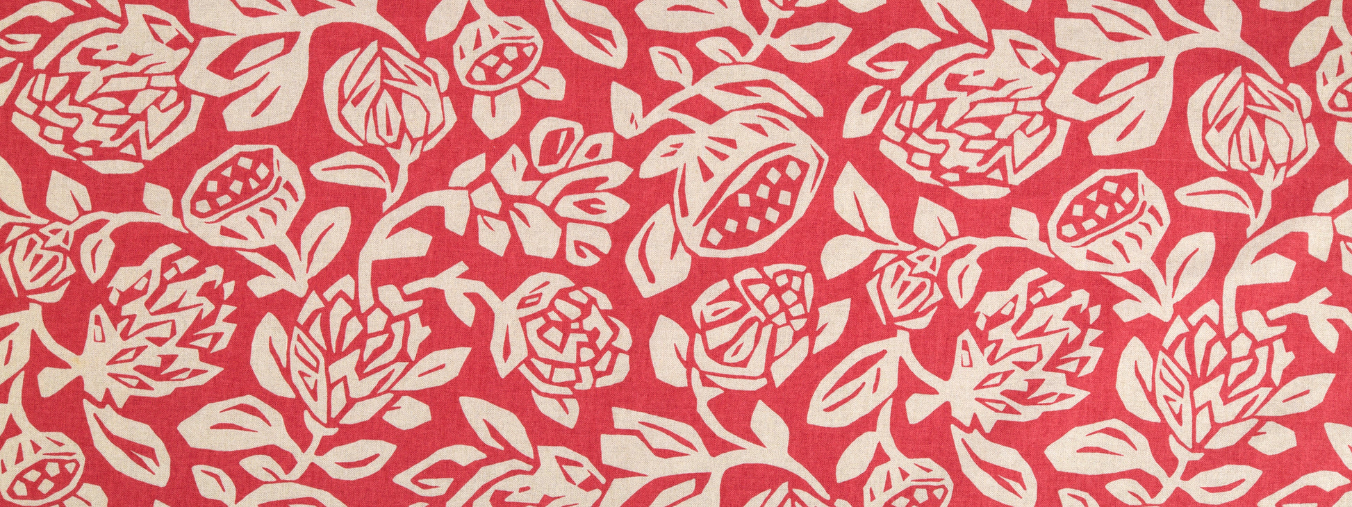 Coral fabric with white roses and leaves in a repeating floral pattern.