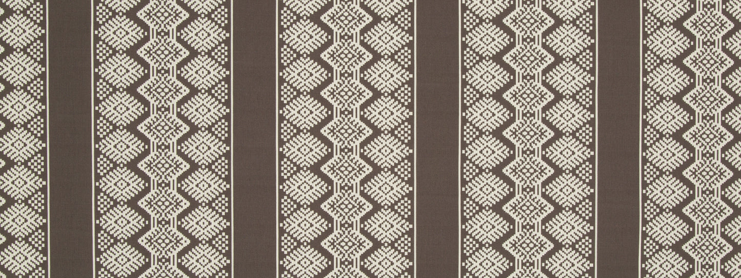 Brown woven upholstery fabric with vertical dark stripes and beige geometric diamond pattern; tribal textile-inspired design.