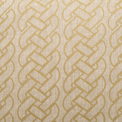 Beige fabric with a gold-toned interlocking braided pattern and woven texture, visible on a decorative pillow.
