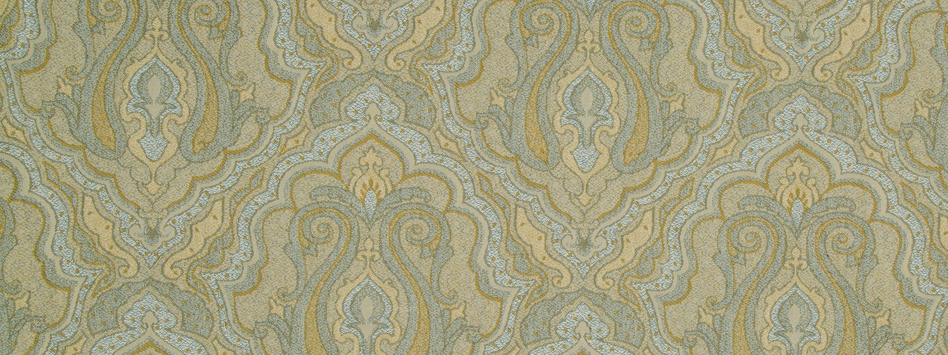 Damask upholstery fabric in gold, teal & pale blue with ornate scrolls & floral motifs on a muted beige background.