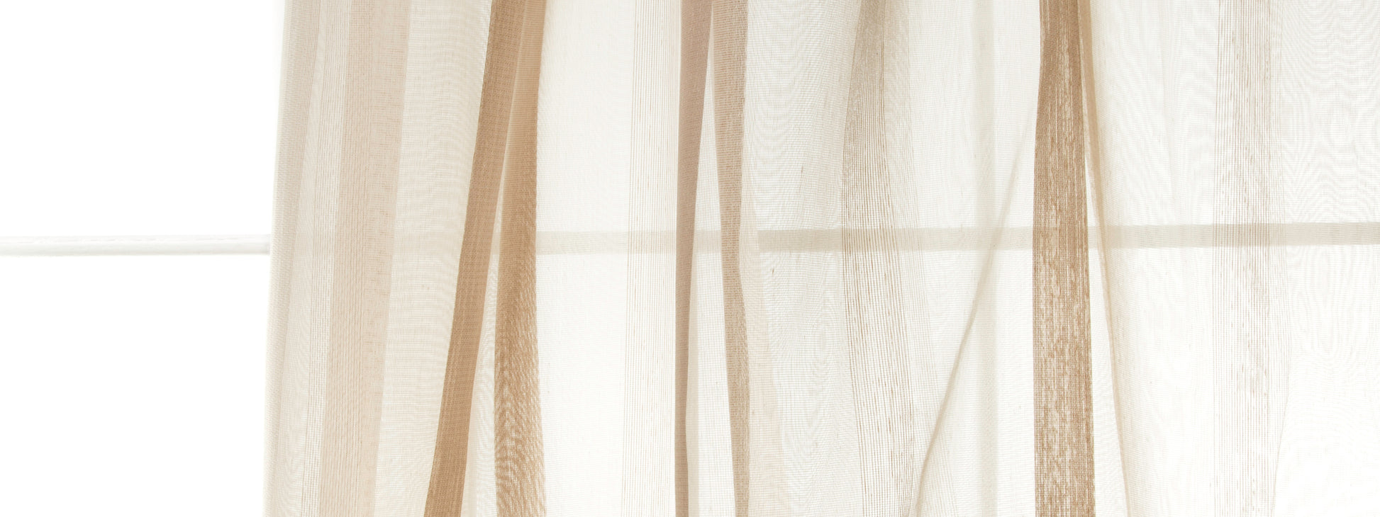 Khaki sheer curtain panels filtering soft window light; lightweight, airy drapery for modern home decor.