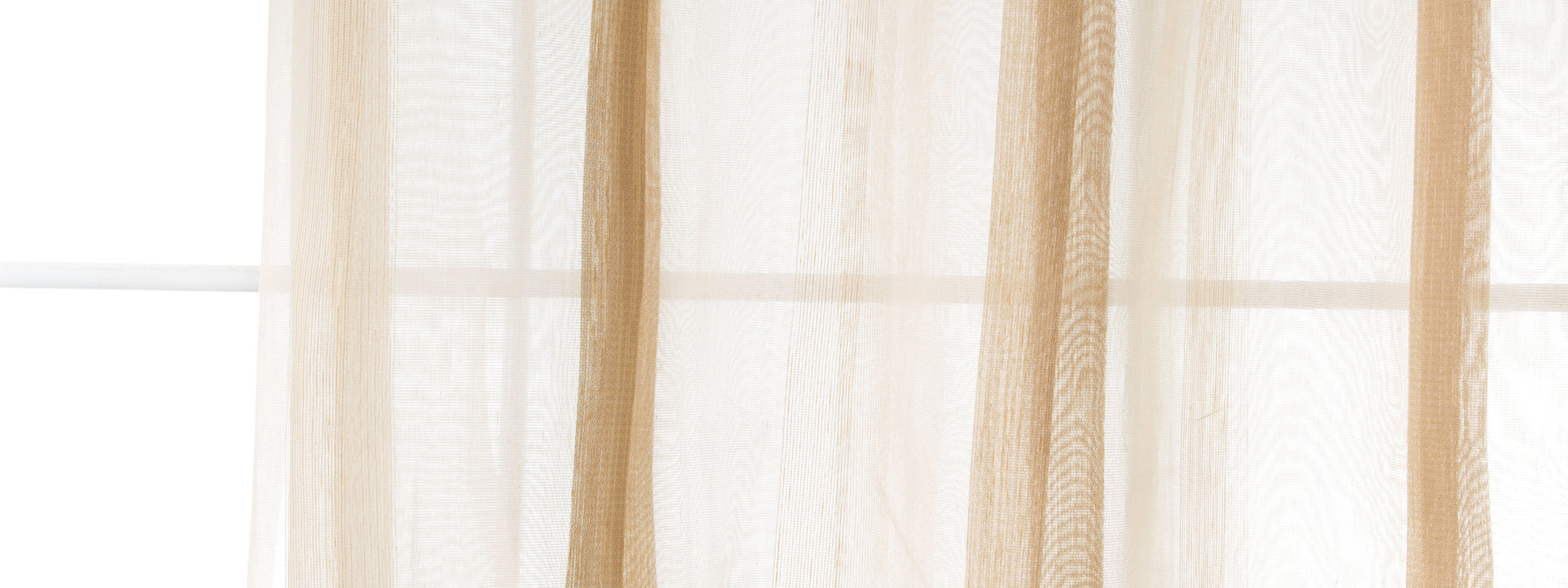 Beige sheer curtain panels in light-filtering fabric, soft vertical folds by a sunlit window.