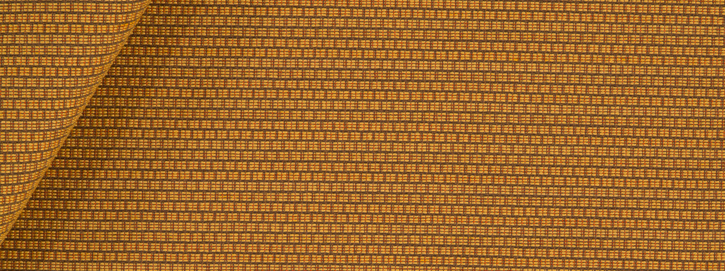 Amber upholstery fabric with a tiny square grid pattern; folded corner.