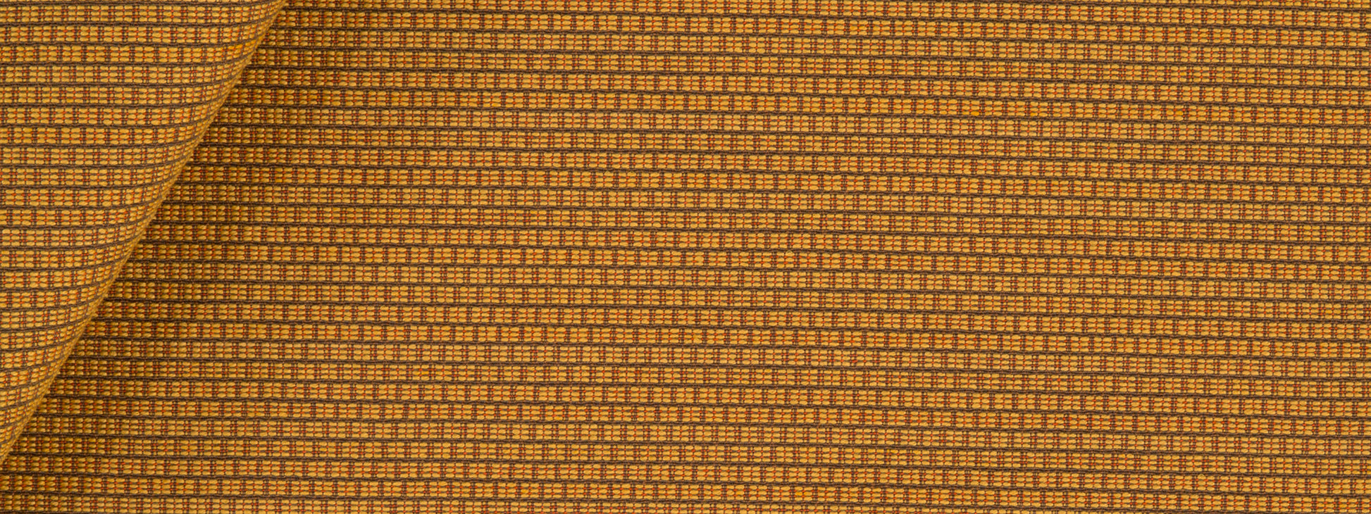 Amber upholstery fabric with a tiny square grid pattern; folded corner.