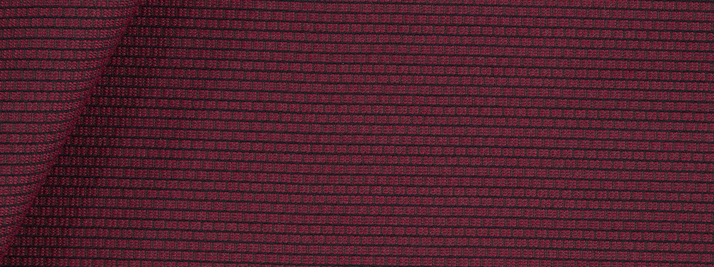 Maroon woven fabric with a tiny grid checker pattern and subtle texture, lightly folded at the top-left.