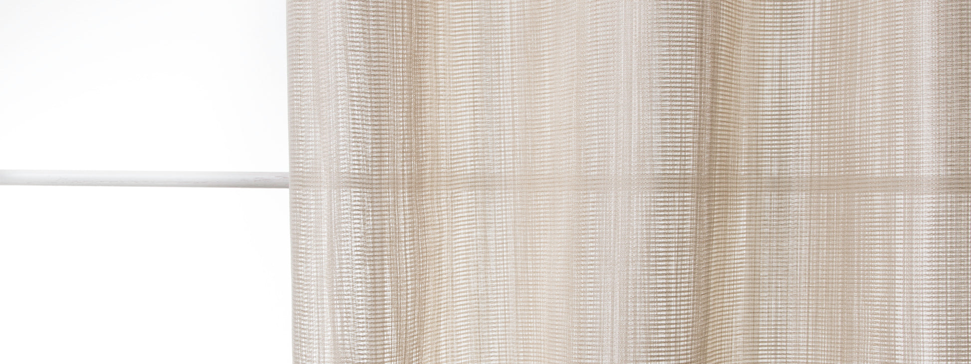Cream-beige sheer curtain with woven vertical stripes, diffusing soft light at a window.