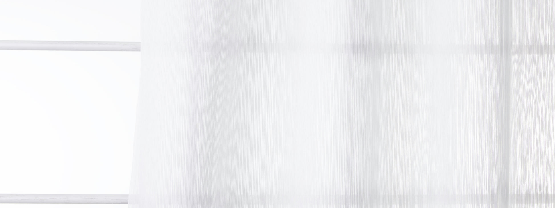 Bone-colored sheer drapery panel with soft folds diffusing natural light for an airy window look.