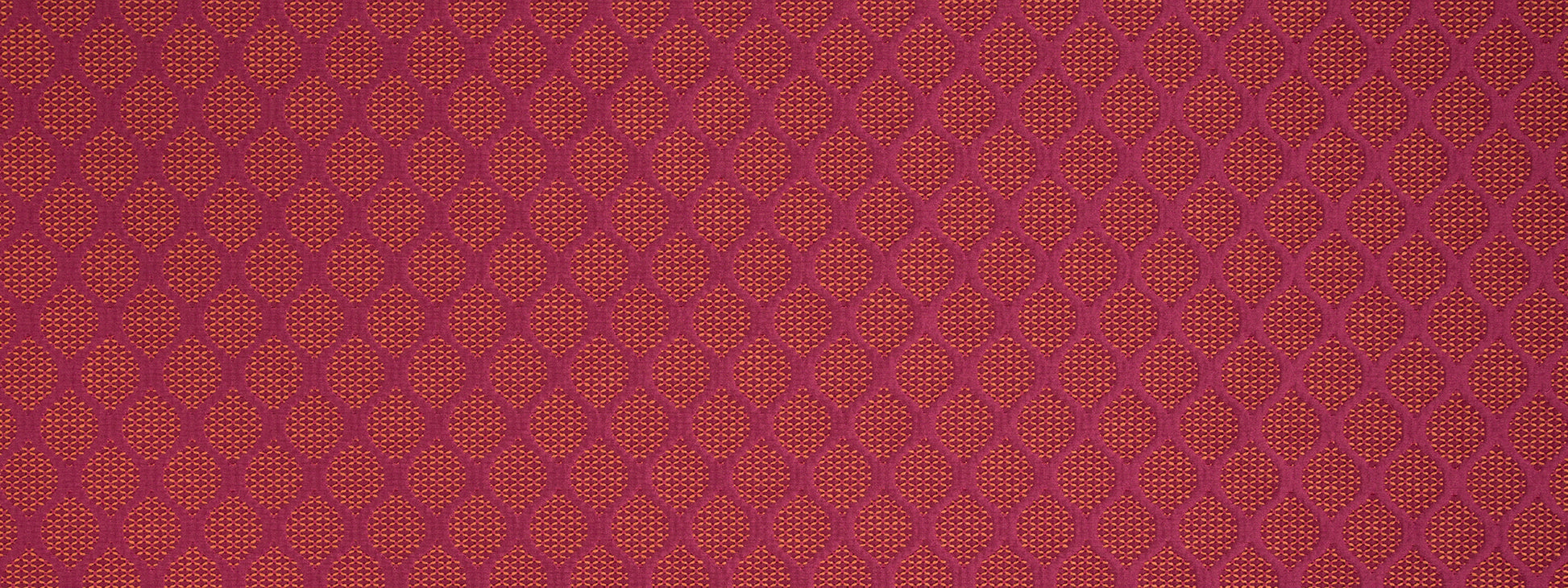 Maroon fabric pattern with small orange lattice motifs in a repeating geometric damask design.
