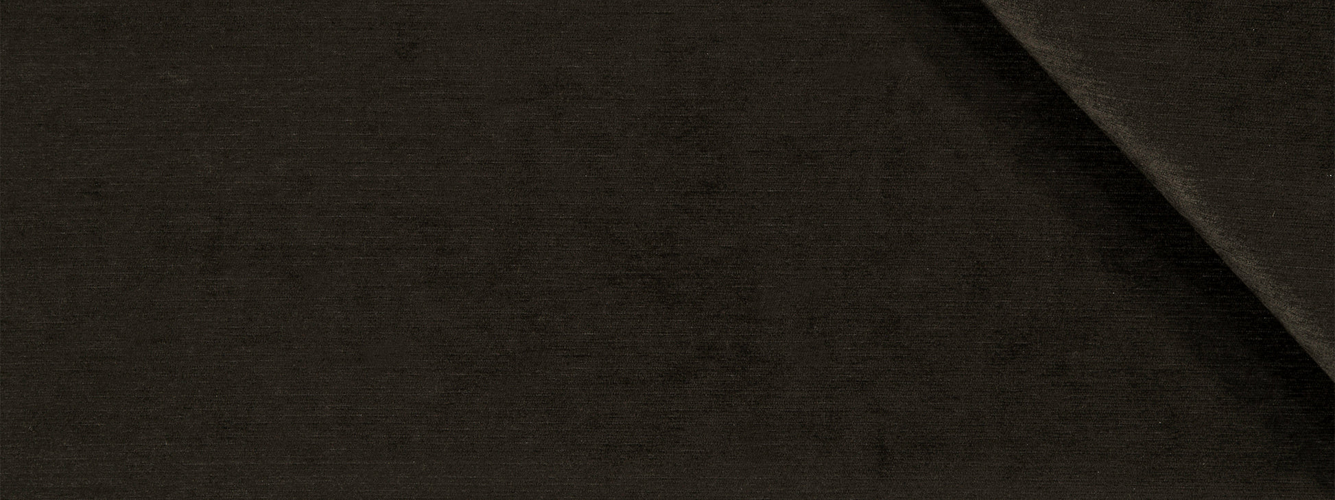 Dark brown fabric close-up with subtle texture and diagonal fold.