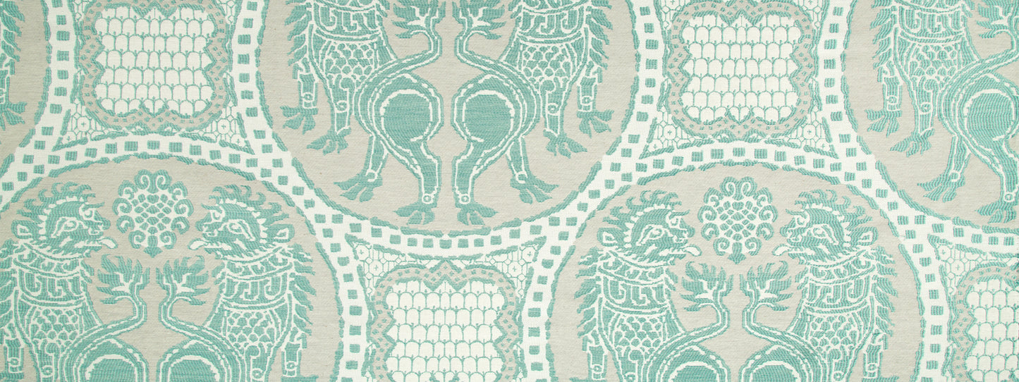 Teal damask-style upholstery fabric pattern with ornate medallions, vines and scrollwork on a light beige background.