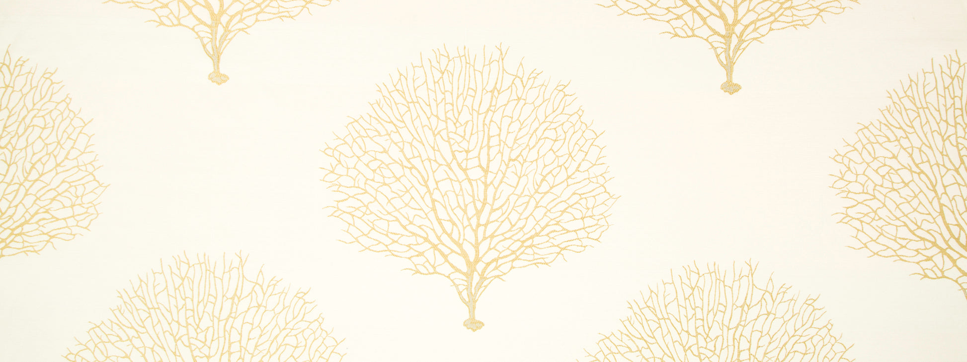 Cream upholstery fabric featuring repeating golden tree-branch motifs for a coastal botanical look.