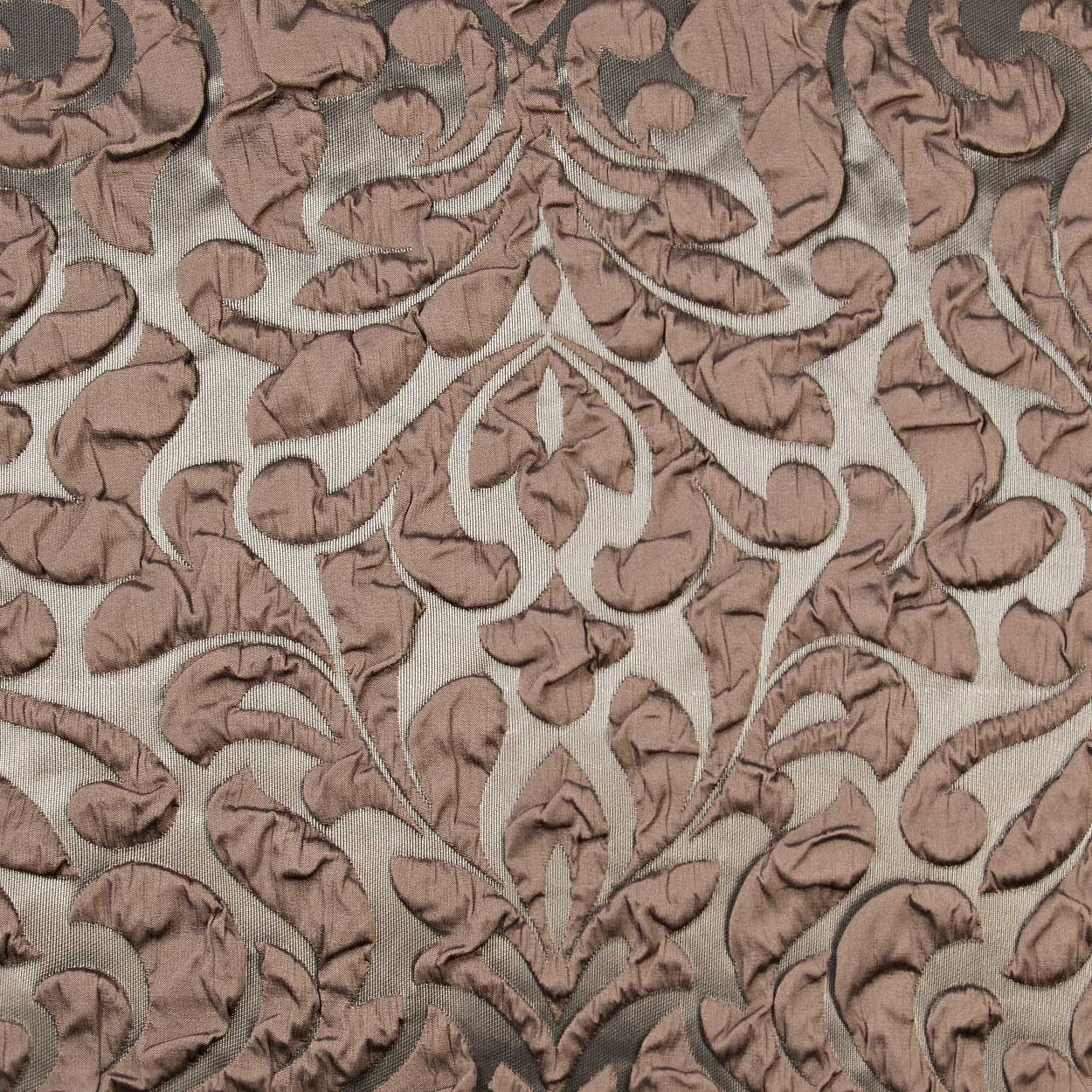 Brown damask velvet jacquard fabric with raised scrolling leaf pattern on beige background, decorative upholstery textile.