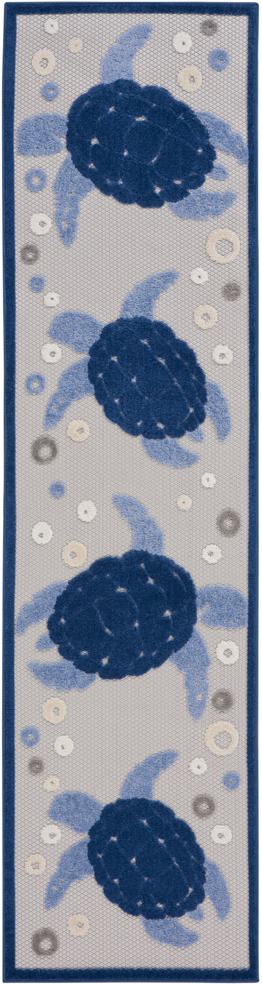 Rectangular tufted rug runner with navy sea turtles and light-blue flippers on gray background, dark blue border.