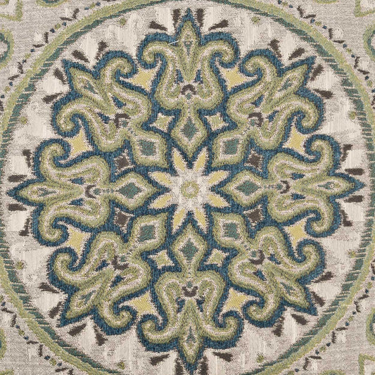 Circular mandala-inspired textile rug pattern in teal, sage green & cream on beige background.