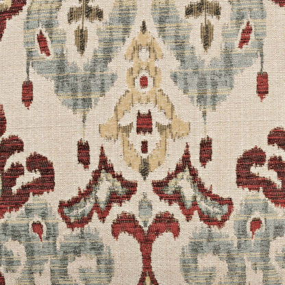 Beige woven pillow with damask-inspired red and pale blue floral arabesque pattern.