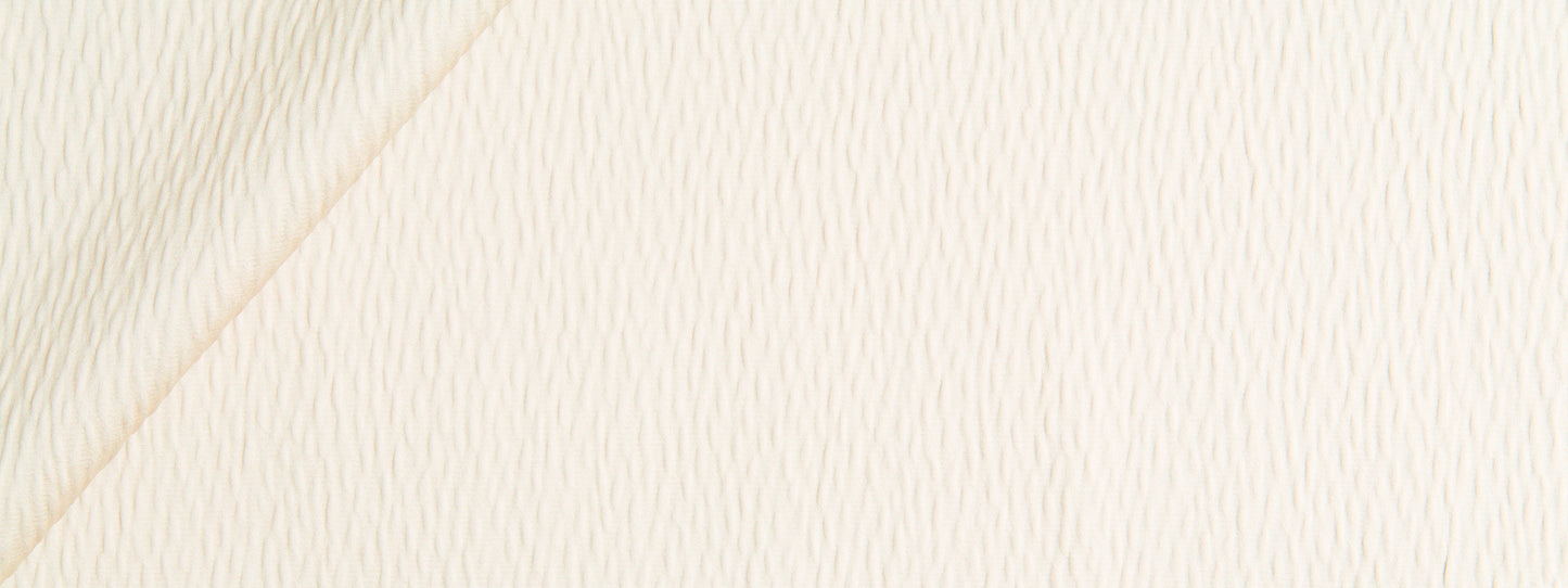 Straw-colored ripple solid fabric with a diagonal seam and subtle weave texture.
