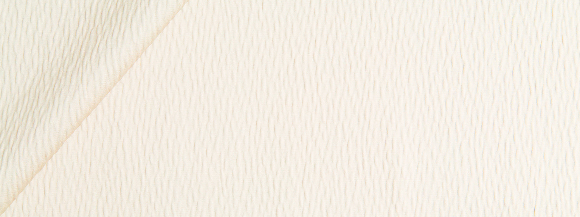 Straw-colored ripple solid fabric with a diagonal seam and subtle weave texture.