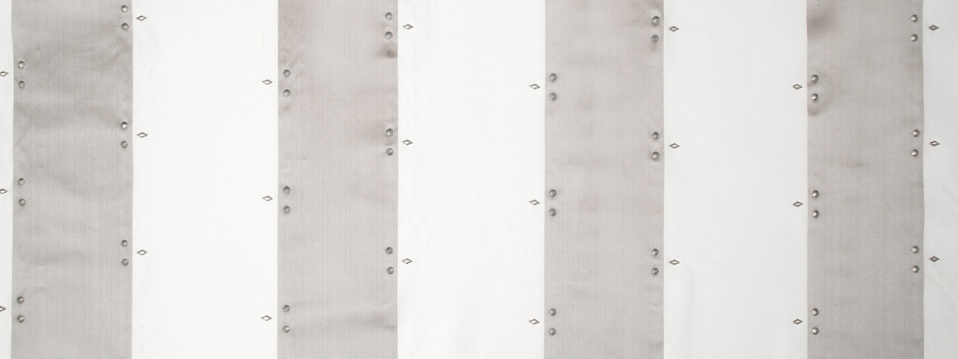 Vertical white and light-gray striped drapery panels in silver tones.