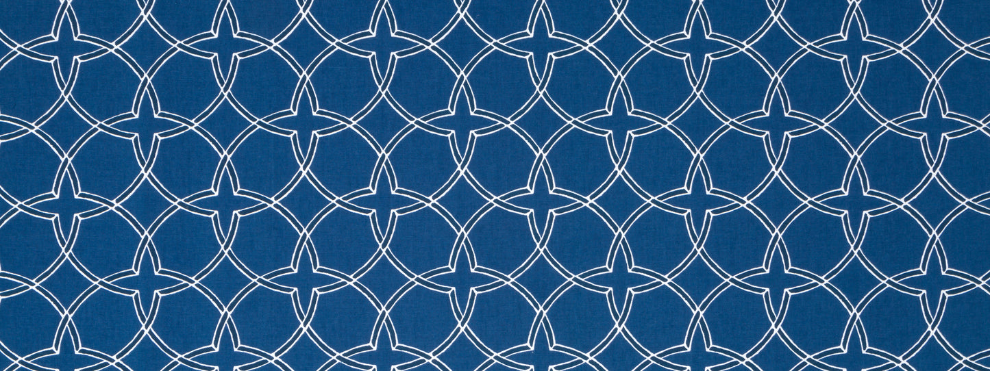 Indigo fabric with white interlocking circular lattice pattern; decorative geometric repeat.