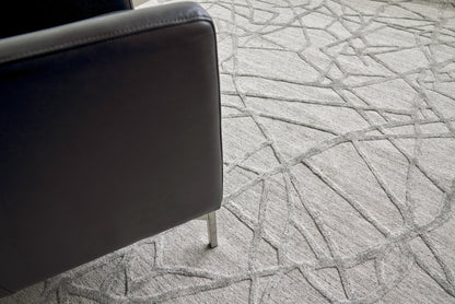 Light gray geometric patterned indoor hand loomed rug.