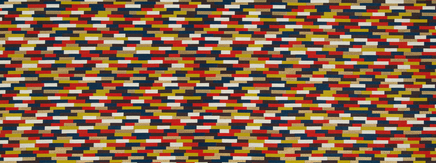Dense multicolor Moroccan Tile pattern upholstery fabric with a tile-like arrangement of small rectangular blocks in red, blue, yellow, white, black.