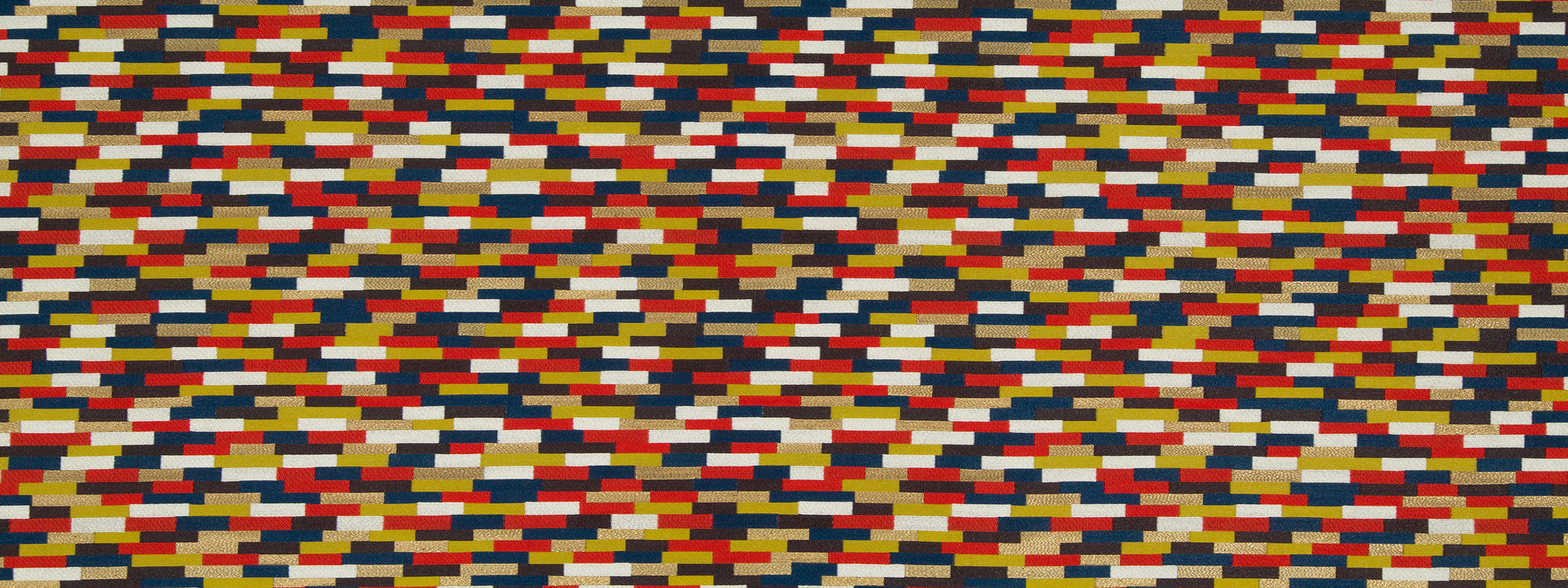 Dense multicolor Moroccan Tile pattern upholstery fabric with a tile-like arrangement of small rectangular blocks in red, blue, yellow, white, black.