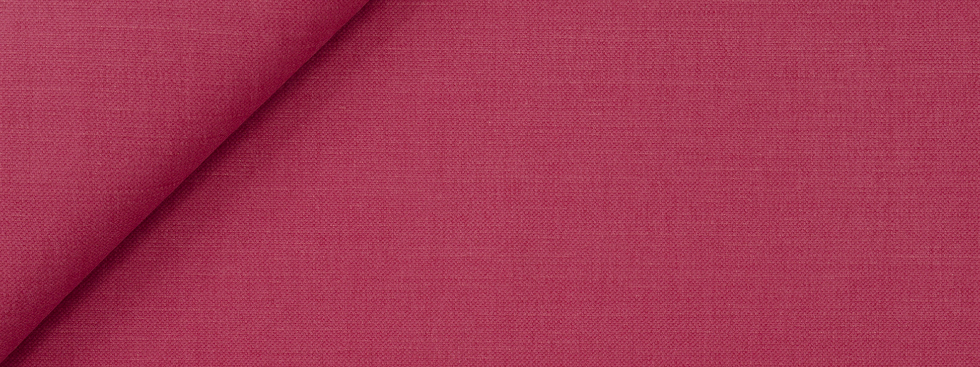 Fuchsia woven upholstery fabric close-up with visible texture and a folded edge