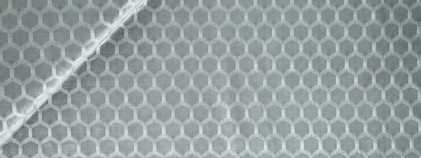 Close-up of pewter gray Soft Hex fabric with a hexagonal honeycomb pattern and a white diagonal seam.