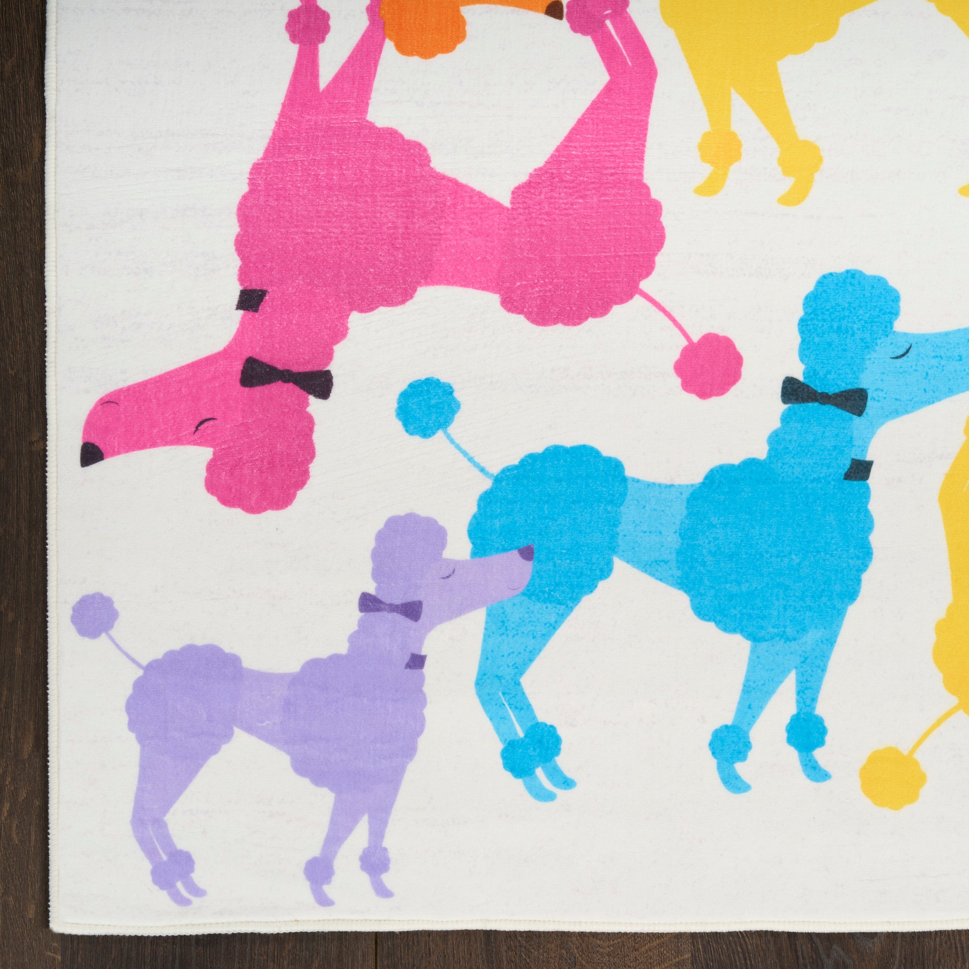 Colorful poodle silhouettes in pink, blue, purple and yellow on white rug; kids' 4' x 6' rug with a playful modern dog-themed print for home decor.