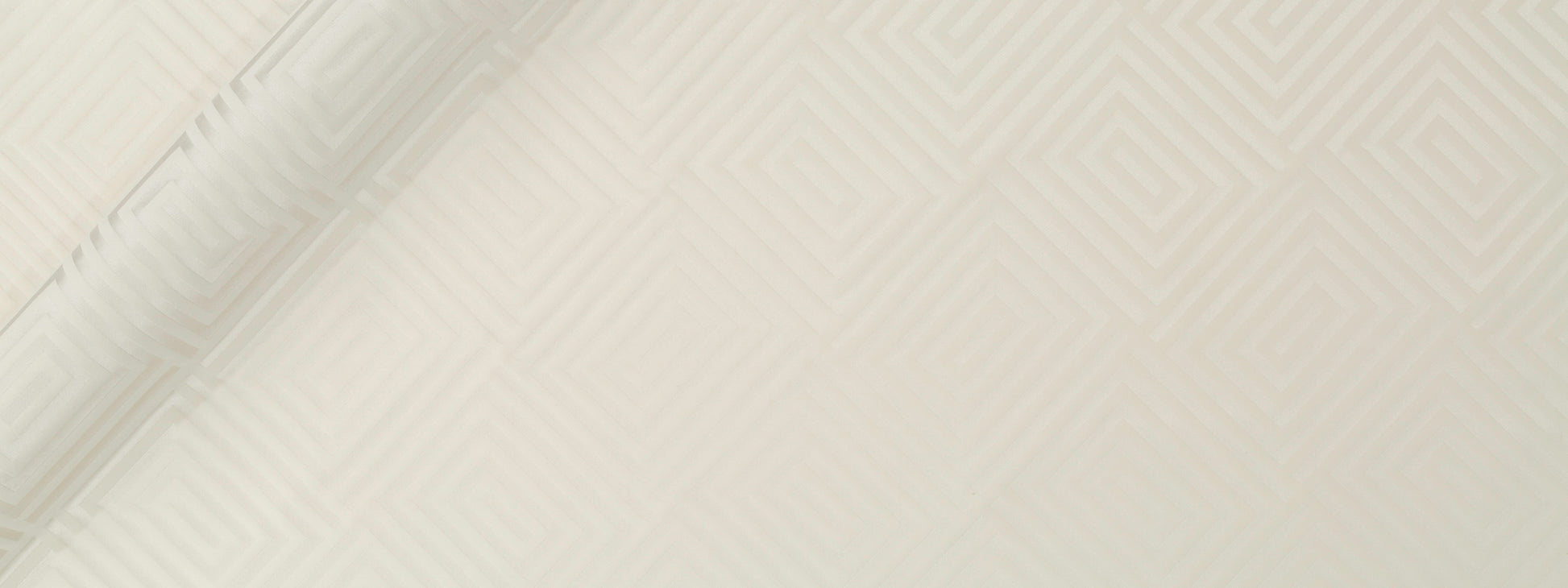 Cream textured upholstery fabric with a subtle diamond pattern and a soft fold along the left edge.