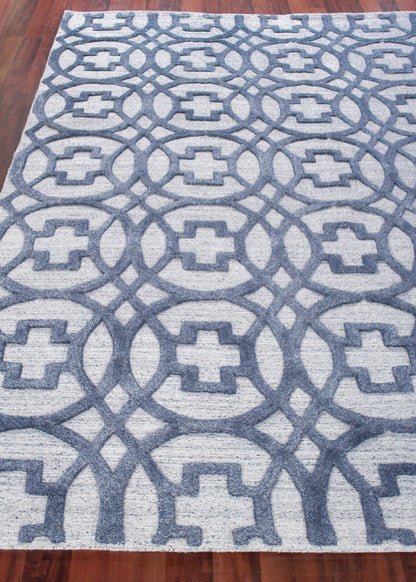 Rectangular blue and light gray geometric rug with an interlocking loop pattern.