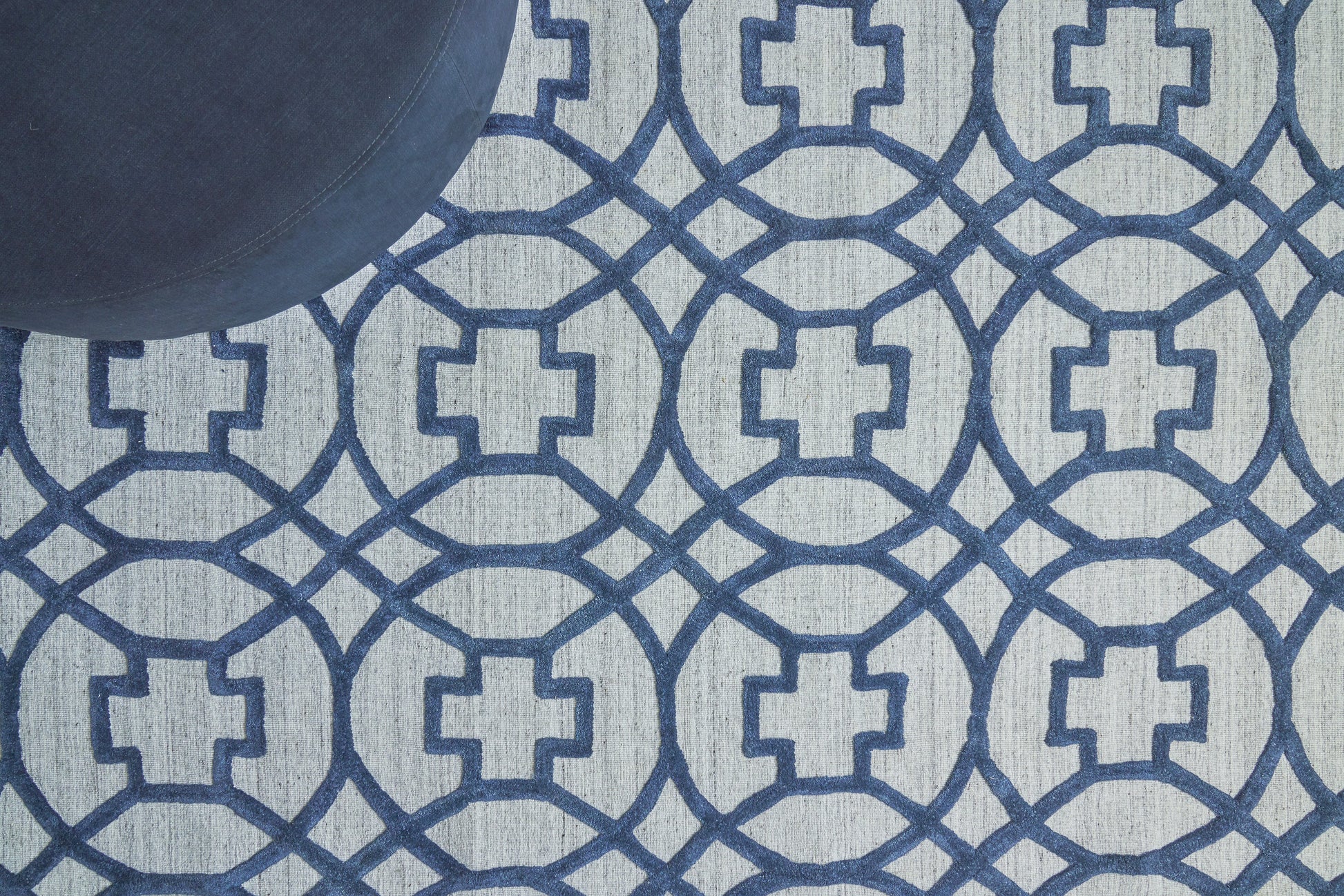 Light blue rug with a navy geometric interlocking circle pattern.