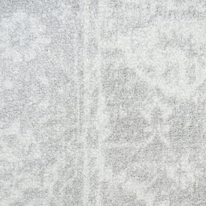 Light grey plush rug with subtle mottled pattern; soft textured pile, modern neutral decor.