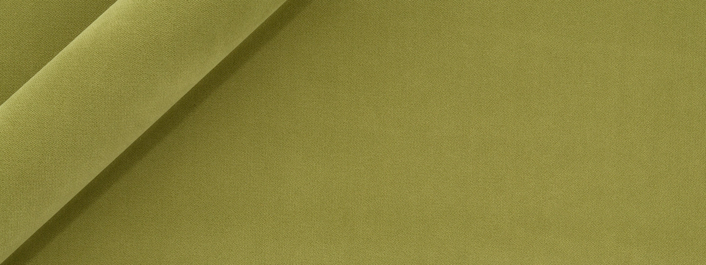 Apple green velvet upholstery fabric, folded with plush texture; close-up detail.